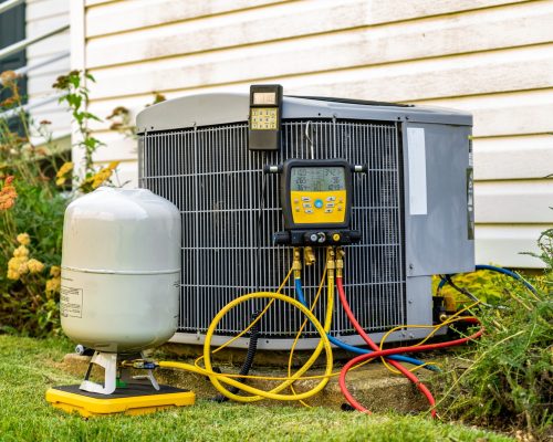 An,Old,Air,Conditioning,Unit,That,Is,Being,Repaired,By